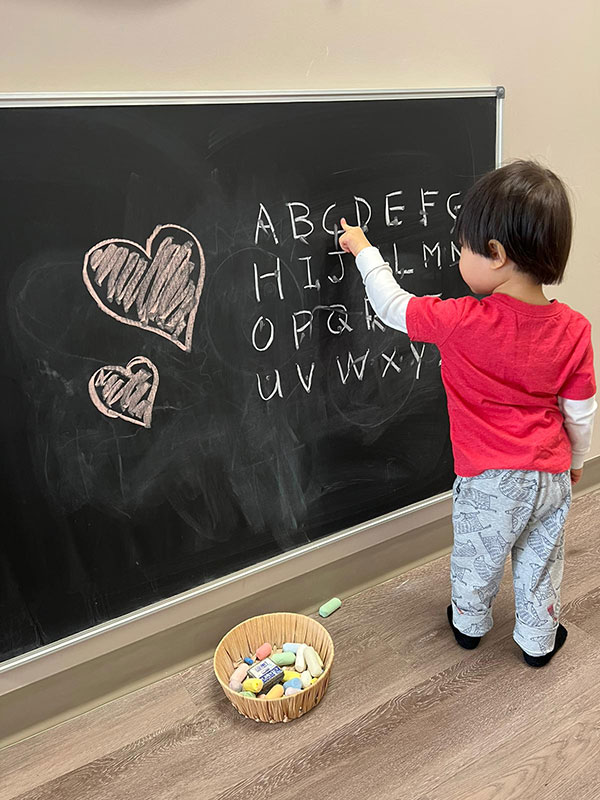 Kid writing on a school board